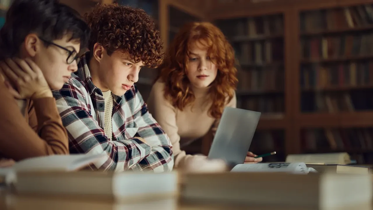 Two mint chocolate milkshakes with whipped cream and green sprinkles.