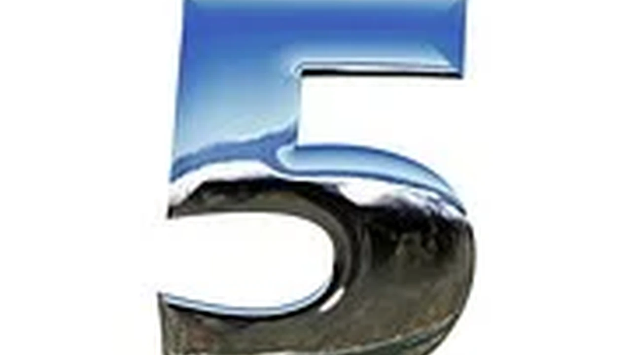 overhead view of corned beef sliced and on a platter with cabbage, potatoes, and carrots