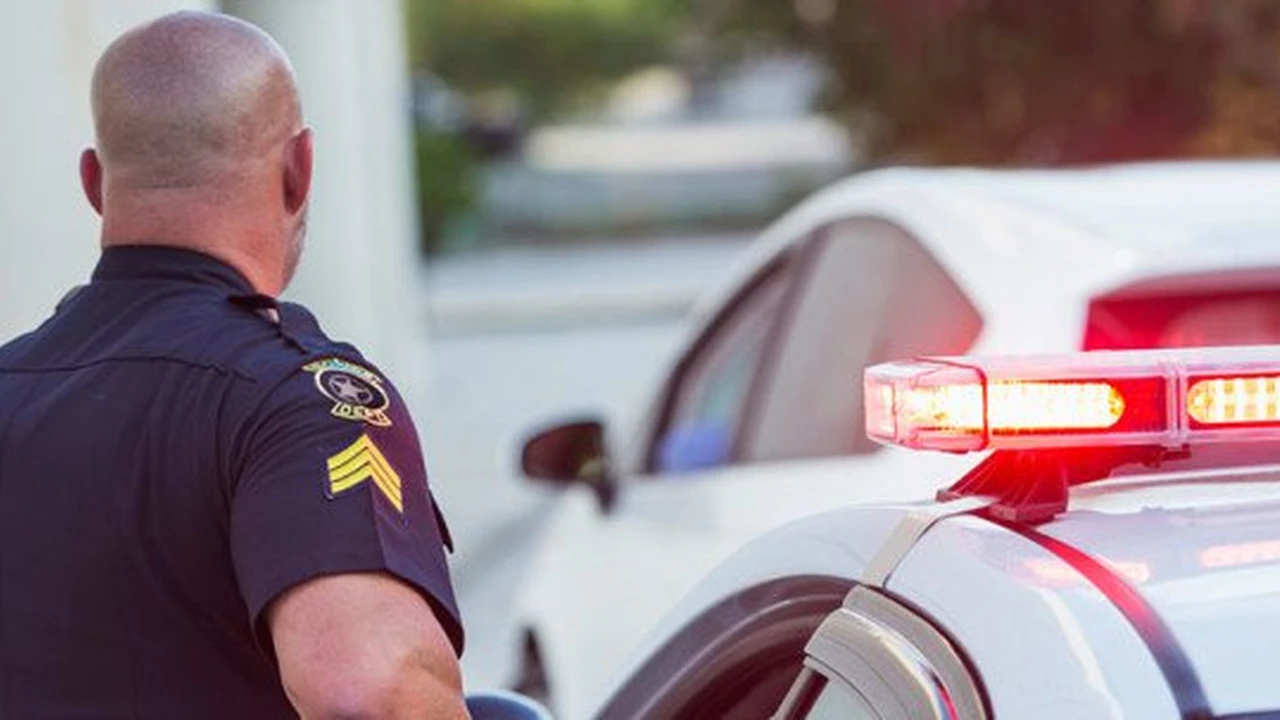 Close up on a plate of mashed potatoes, topped with baked pork chops with cream of mushroom soup, and a side of green beans.
