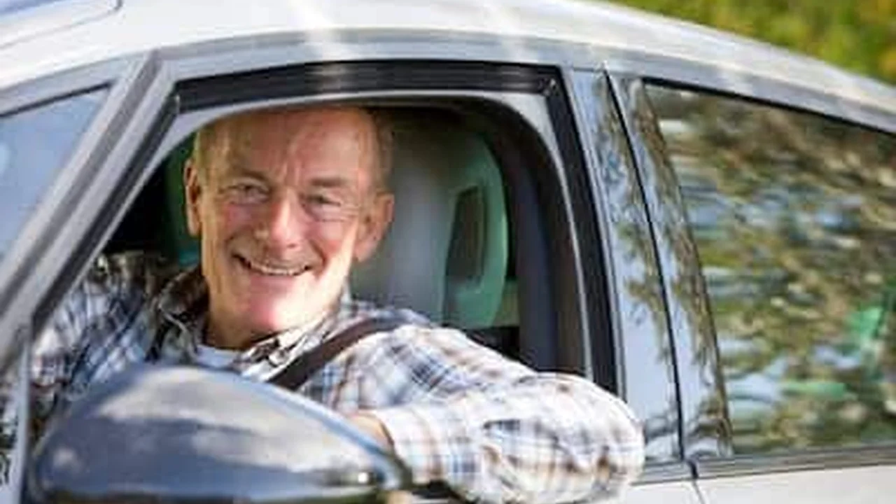 Close up on a plate of mashed potatoes, topped with baked pork chops with cream of mushroom soup, and a side of green beans.