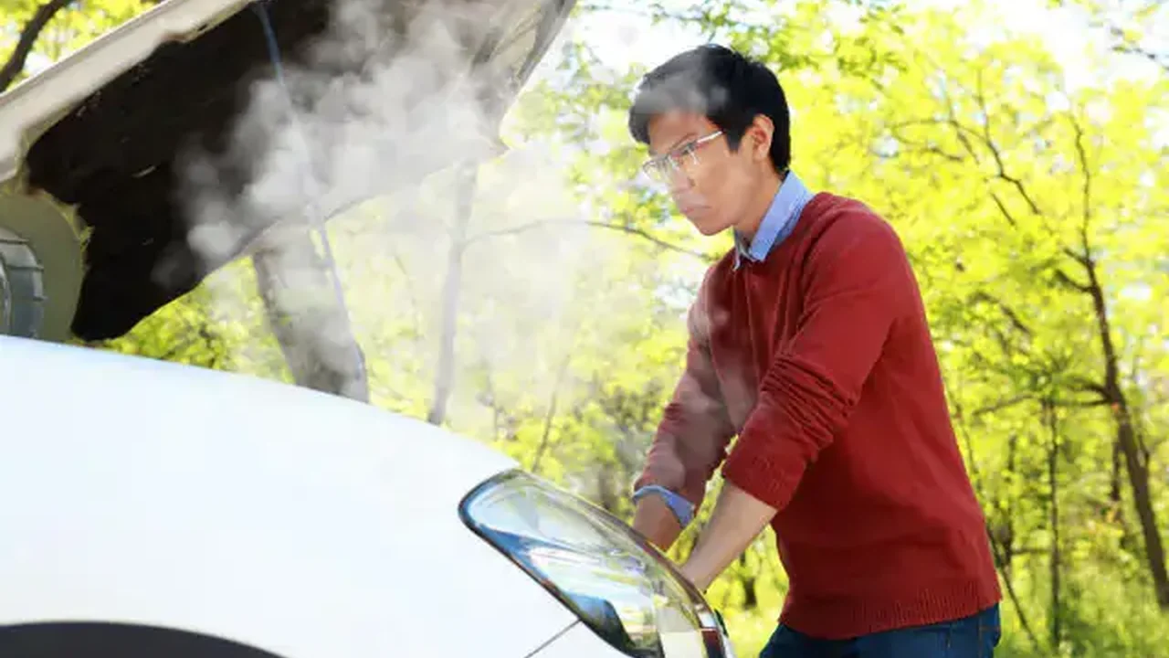 Close up on a plate of mashed potatoes, topped with baked pork chops with cream of mushroom soup, and a side of green beans.