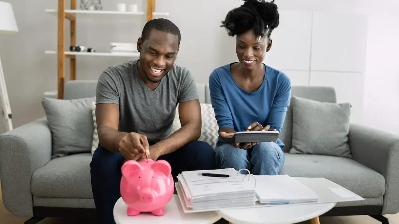 Close up on a plate of mashed potatoes, topped with baked pork chops with cream of mushroom soup, and a side of green beans.