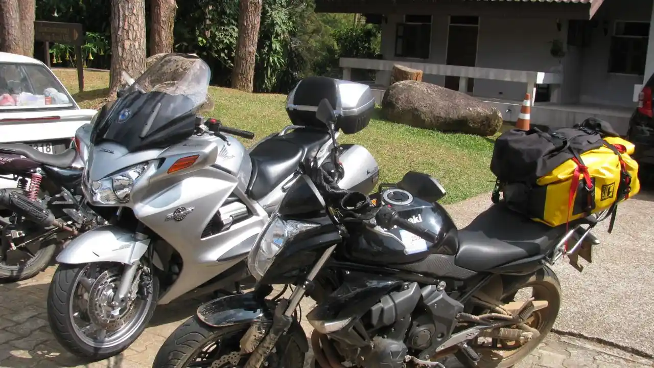 Close up on a plate of mashed potatoes, topped with baked pork chops with cream of mushroom soup, and a side of green beans.